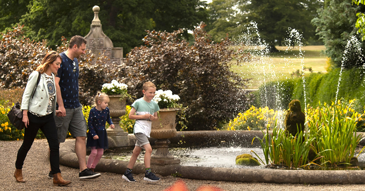 family walking through the walled gardens at Raby Castle 